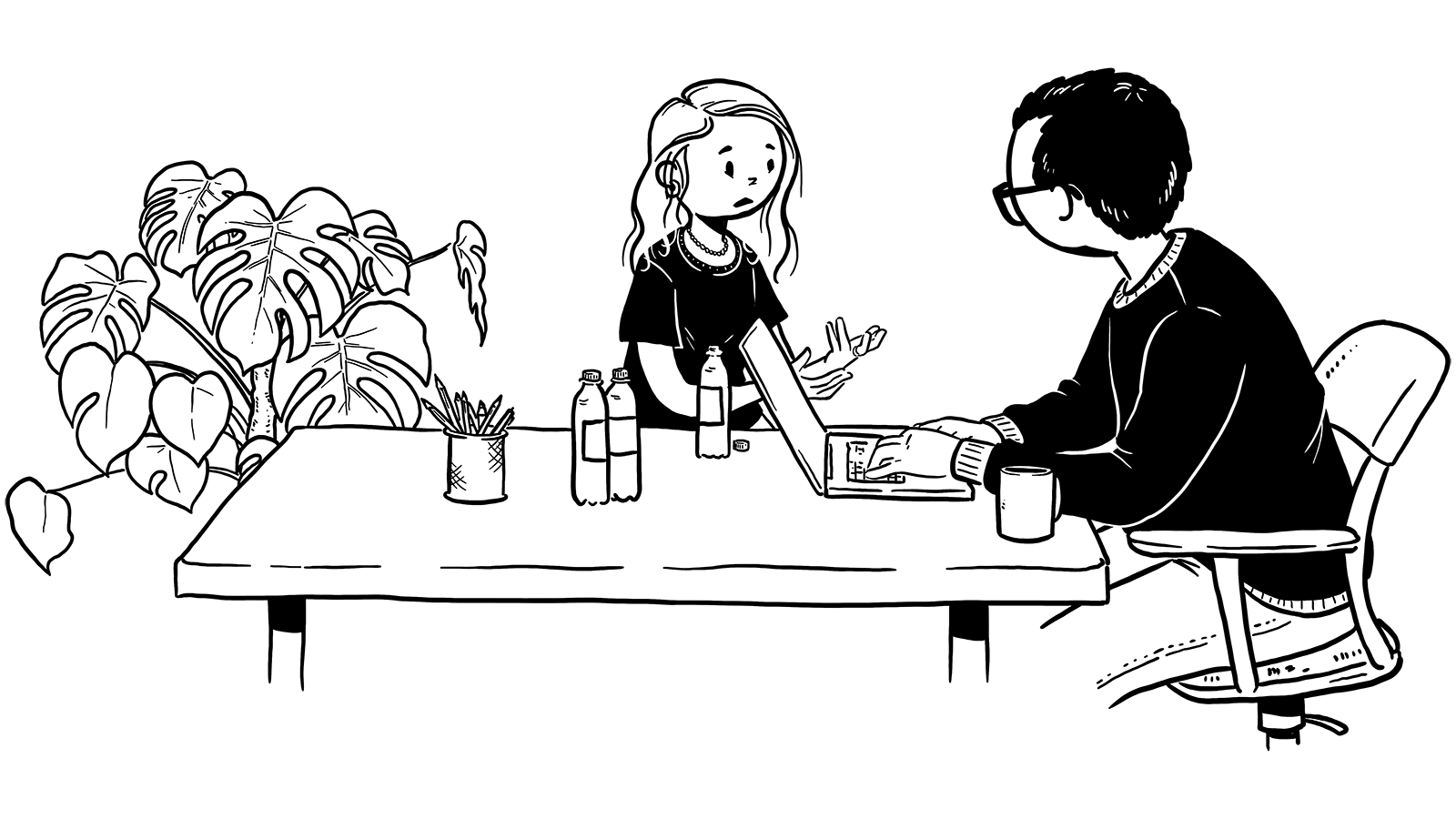 Pige og mand sidder ved bord og taler sammen. Manden tager noter på sin computer.